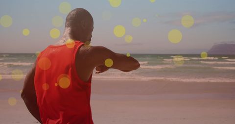 Athletic Man Checking Smartwatch on Sunlit Beach - Download Free Stock Images Pikwizard.com