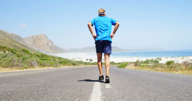 Man Running on Coastal Road with Scenic Mountain View - Download Free Stock Images Pikwizard.com