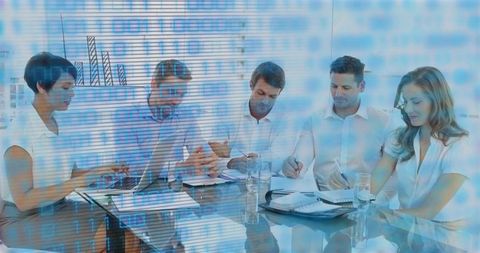 Business team collaborating around laptop with digital data overlay for corporate planning