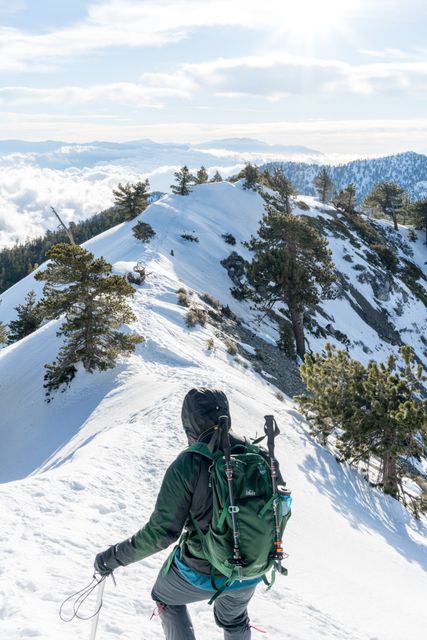 Hiker Climbing Snow-Covered Mountain Ridge on Sunny Winter Day - Download Free Stock Photos Pikwizard.com
