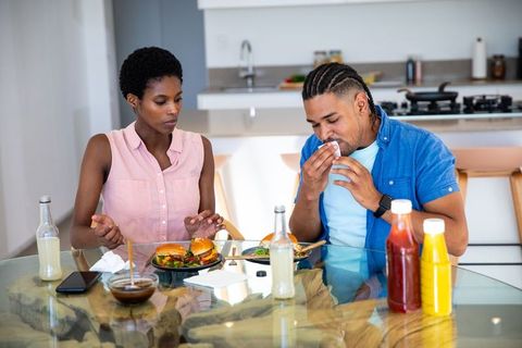 Couple Enjoying Burgers and Drinks at Modern Dining Table