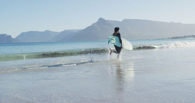 Surfer Running Into Ocean On Sunny Day - Download Free Stock Images Pikwizard.com