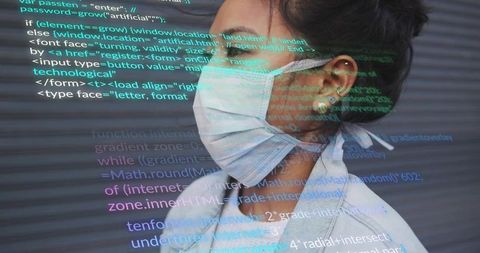 Asian woman wearing surgical mask and lab coat with code projection, futuristic healthcare