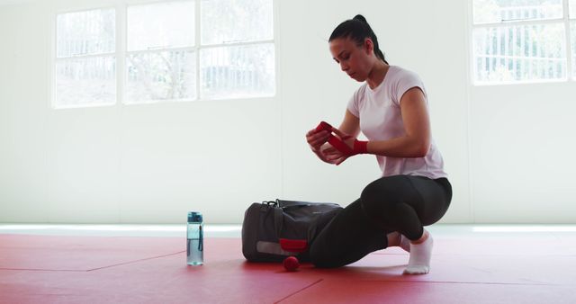 Female Athlete Wrapping Hands Preparing for Workout in Gym - Download Free Stock Images Pikwizard.com