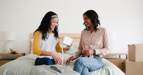 Mother and Daughter Joyfully Unpacking during Moving Day