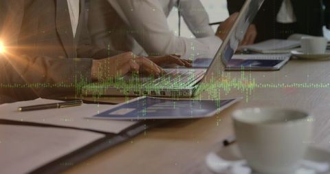 Business Team Analyzing Data on Laptop with Glowing Charts