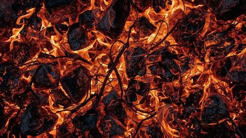 Intense flames with charred logs and embers