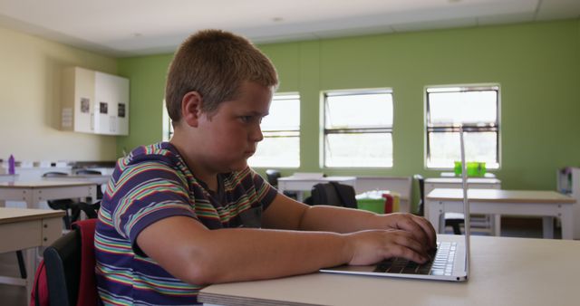 Focused Male Student Typing on Laptop in Classroom - Download Free Stock Images Pikwizard.com