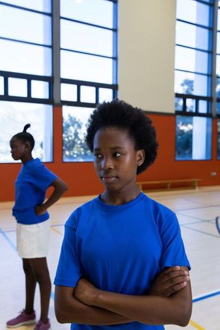 Determined Young Girls in Gymnasium Embracing Sports Culture