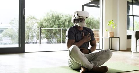 Senior Man Enjoying Virtual Reality Experience in Living Room