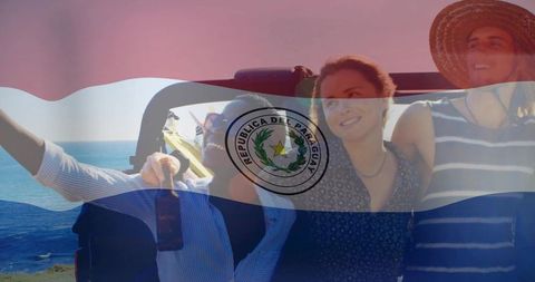 Friends enjoying coastal convertible road trip with paraguay flag overlay