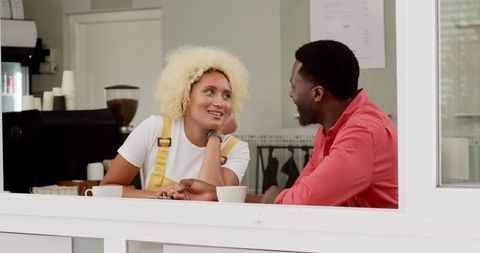 Happy biracial couple enjoying coffee date
