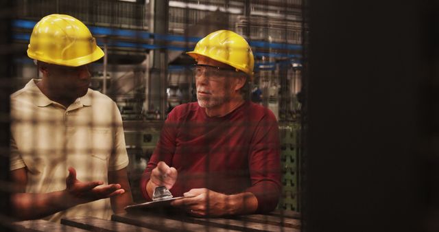 Factory Workers Discussing Production Plan with Clipboard - Download Free Stock Images Pikwizard.com