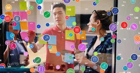 Diverse team brainstorming ideas with digital technology overlay