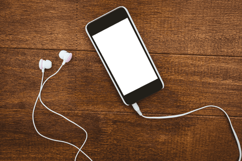 transparent smartphone and headphones on wooden surface - Download Free Stock Videos Pikwizard.com