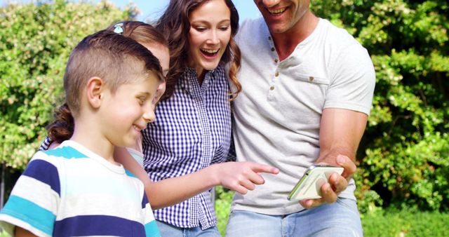 Family Spending Time Together Outdoors Looking at Smartphone - Download Free Stock Images Pikwizard.com