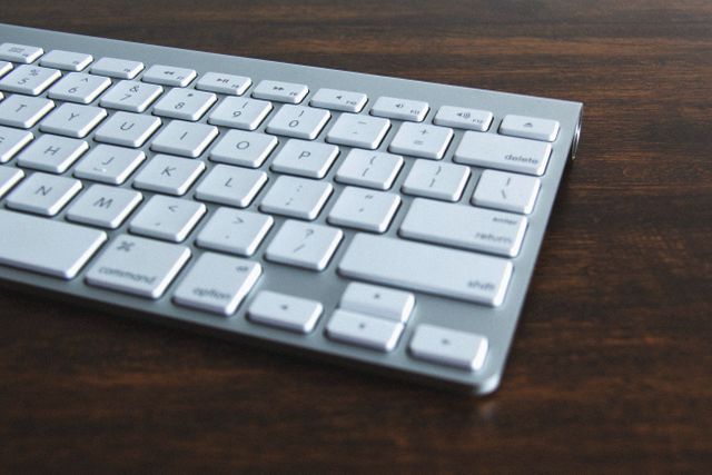 Modern Silver Computer Keyboard on Wooden Desk - Download Free Stock Photos Pikwizard.com