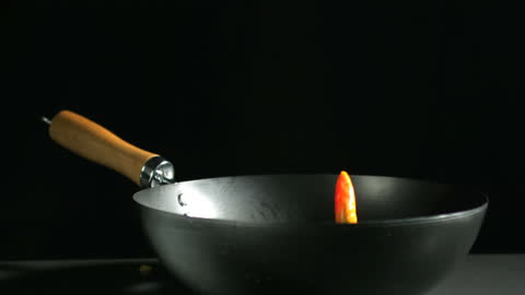 Jalapeno Pepper Falling into Wok in Slow Motion