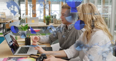 Coworkers Discussing Reports with Digital Interface