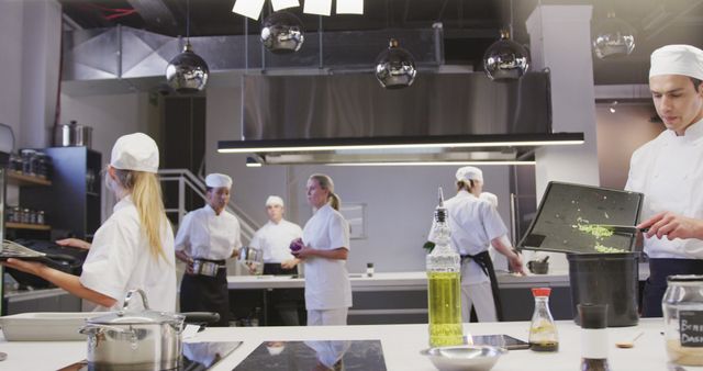 Chefs dressed in white uniforms and caps working together in a modern commercial kitchen. Perfect for illustrating professional culinary environments, restaurant operations, teamwork in culinary settings, and high-quality food preparation.