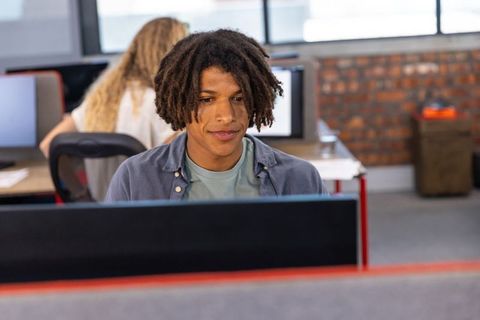 Young professional working in modern open plan office