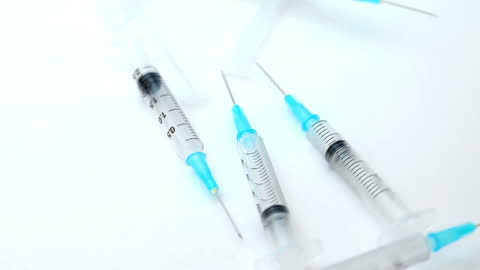 Many Syringes on White Background in Doctors Office