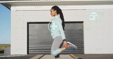 Woman stretching outdoors wearing fitness watch with augmented hud overlay
