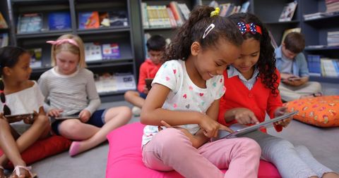 Diverse Schoolchildren Engaged with Tablet in Library - Download Free Stock Images Pikwizard.com