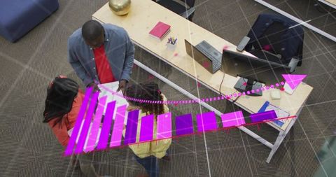 Team collaborating over augmented reality data visualization at modern open office workspace