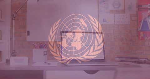 United Nations Symbol on Office Desk with Laptop in Creative Space - Download Free Stock Images Pikwizard.com