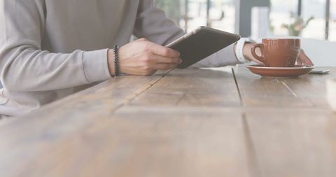 Woman Using Smartphone in Café with Fingerprint Overlay