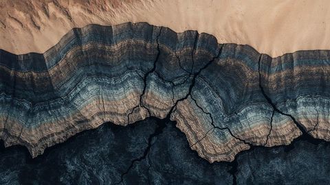 Aerial view of sedimentary rock layers and cracks