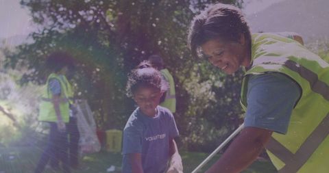 Diverse Volunteers Collecting Litter in Scenic Countryside