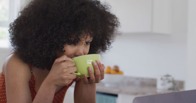 Young Girl Enjoying Hot Beverage in Modern Kitchen - Download Free Stock Images Pikwizard.com