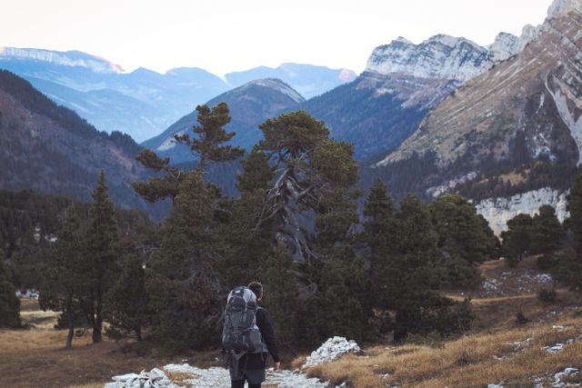 Backpacker Hiking Through Mountainous Wilderness at Sunrise - Download Free Stock Photos Pikwizard.com
