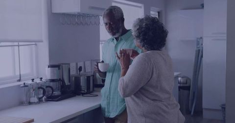 Senior Couple Enjoying Morning Coffee in Modern Kitchen Interior