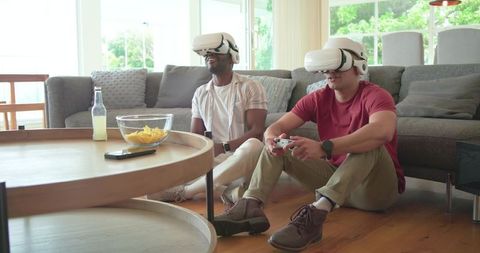 Friends playing immersive VR games in living room with white headsets and controller