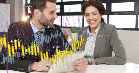 Smiling business colleagues analyzing tablet with financial charts and analytics overlay