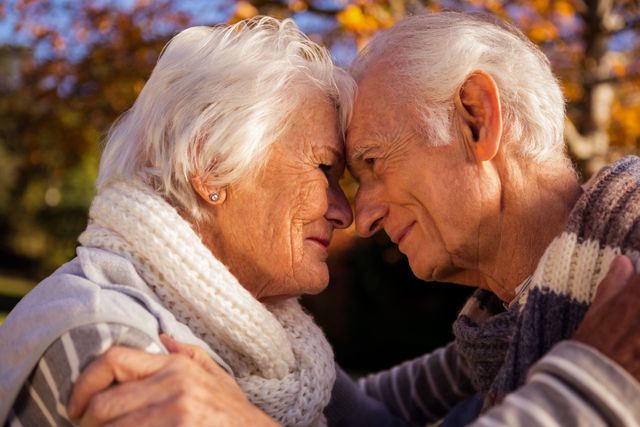 Senior Couple Embracing in Park During Autumn - Download Free Stock Photos Pikwizard.com