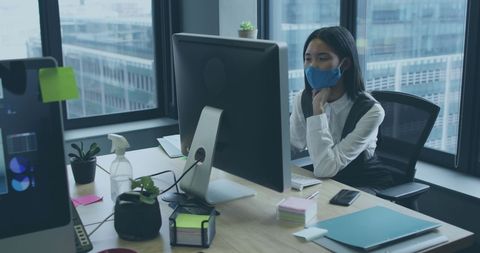Businesswoman Using Computer with Mask in Office During Pandemic - Download Free Stock Images Pikwizard.com