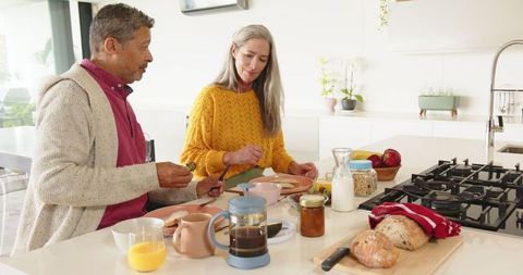 Senior Couple Enjoying Breakfast Together at Kitchen Island