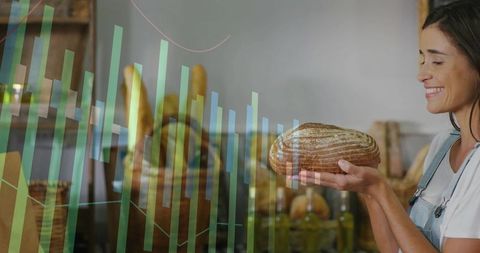 Smiling baker holding sourdough loaf with sales graph overlay showing bakery growth