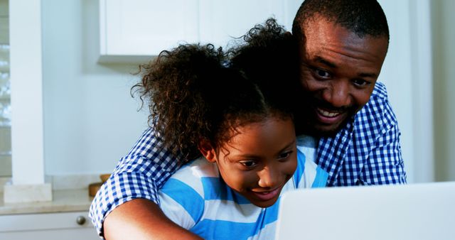 Father and Child Bonding While Using Laptop in Kitchen - Download Free Stock Images Pikwizard.com