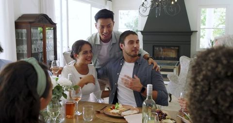 Diverse Group Cheers at Festive Home Gathering