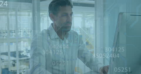 Businessman Analyzing Financial Data on Computer Screen in Office