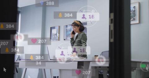 Businesswoman Communicating amid Digital Notifications in Modern Office
