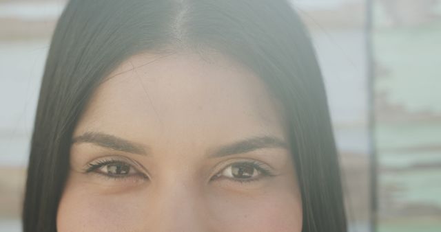 Close-up showing the eyes and part of the face of a young woman with a serene expression. Useful for beauty product advertisements, serenity concepts, and spa promotions. Ideal for blog posts about facial care, makeup, and inner peace.