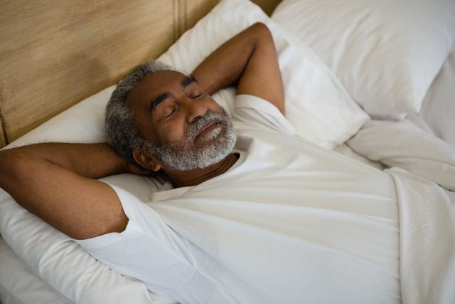 Senior man sleeping on bed in the bedroom at home