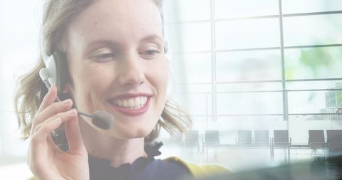 Smiling Businesswoman Communicating through Headset in Office Environment
