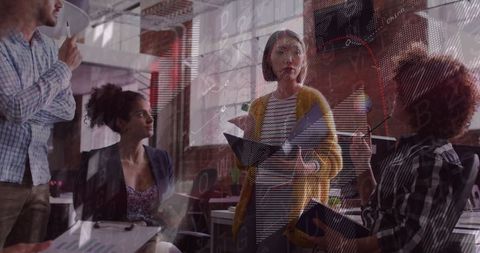 Collaborative Team Analyzing Financial Trends in Modern Office